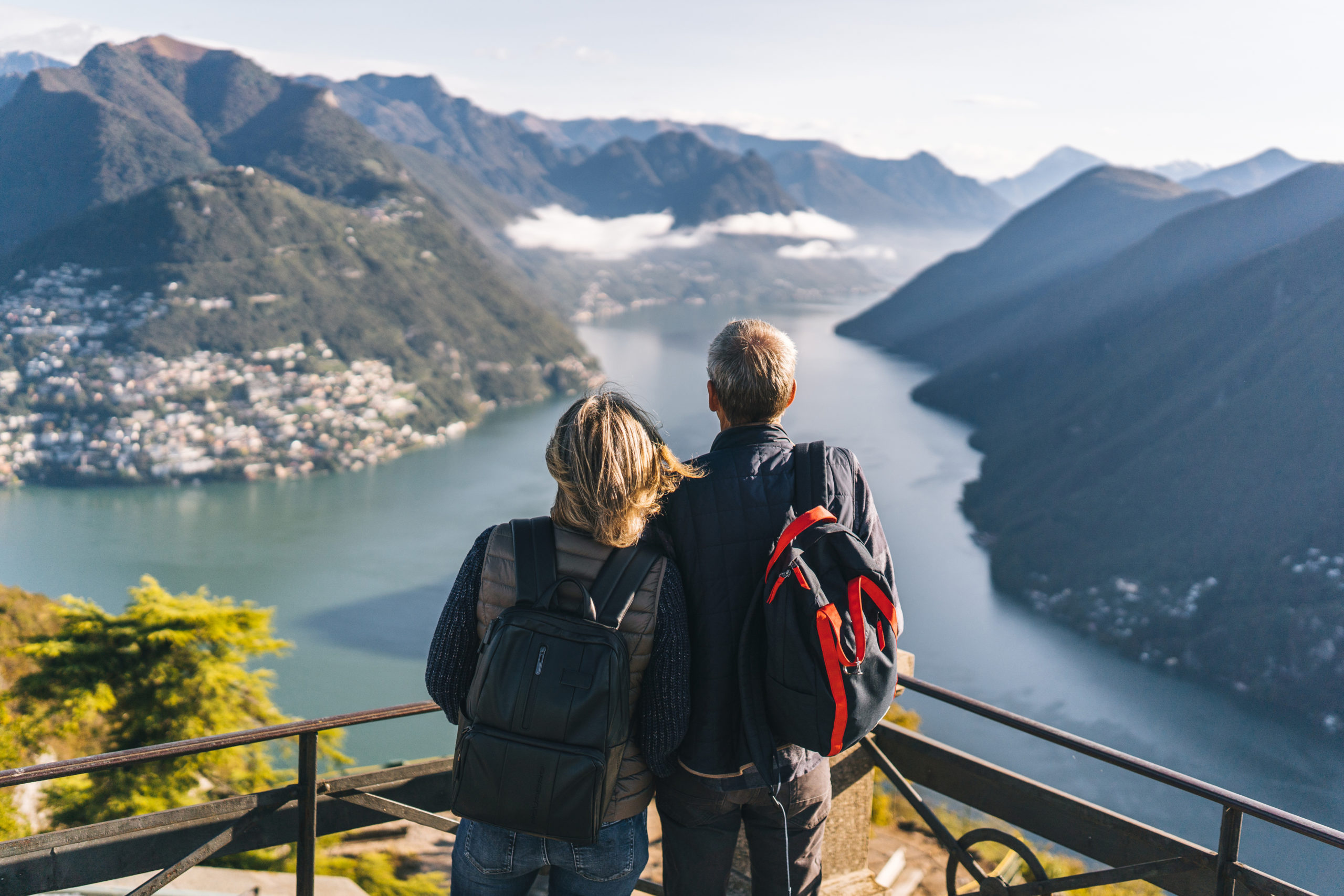 Mature couple hike above lake Lugano in the morning